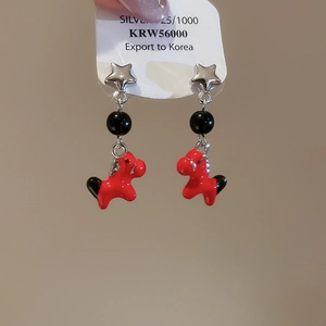 Detail of red enamel horse earrings with silver stars and 925 silver needles