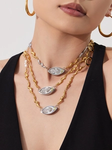Close-up of layered necklace set featuring marquise zircon pendant and freshwater pearl