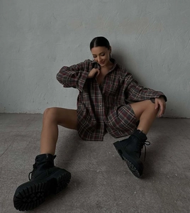 Detail view of vintage plaid oversized shirt with loose long sleeves and lapel collar