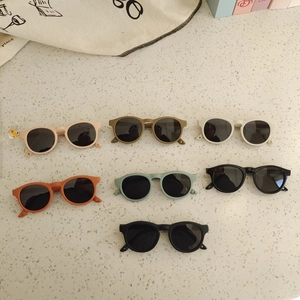 Flat lay of colorful flexible silicone kids sunglasses in seven different pastel shades