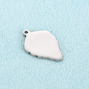 Polished stainless steel leaf pendant charm for necklaces with mirror finish on blue background