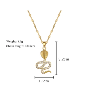 Macro detail of gold cobra pendant with crystal inlay and technical size measurements