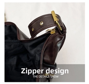 Detail show of dark brown vintage leather shoulder bag with gold zipper and black lining