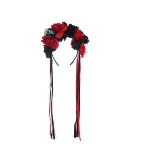 Detail of Halloween headband with red and black roses, silver skulls, and long ribbons