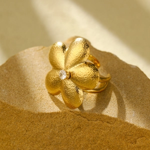 Golden five-petal flower ring with central zircon and hammered metal texture detail