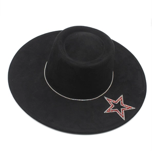 Detail of black wide brim jazz hat featuring a sparkling red and silver rhinestone star