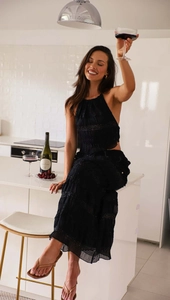 Detail of black tiered sleeveless chiffon set with subtle sequin embellishments