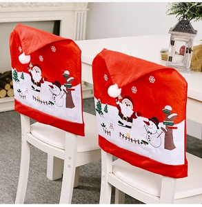 Detail showing Santa and Snowman non-woven chair covers for Christmas dining decor