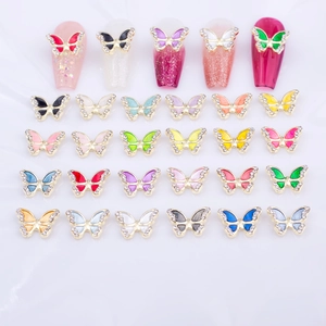 Close-up of 3D alloy butterfly nail art charms with colorful enamel wings and rhinestones