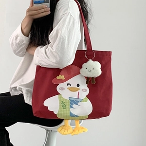Detail of red canvas tote bag with cute cartoon duck print and white cloud charm