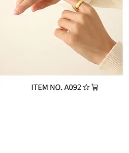 Minimalist gold band ring worn on index finger showing elegant matte finish and slim fit