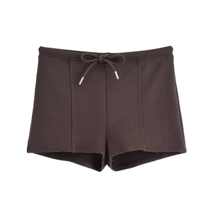 Detailed view of dark brown athletic shorts featuring drawstring waist and metal aglets