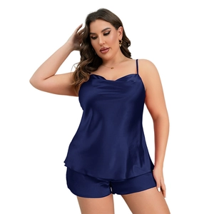 Plus size navy blue satin pajama set featuring camisole top and shorts in glossy fabric