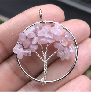 Handmade silver wire tree of life pendant featuring natural pink rose quartz crystals