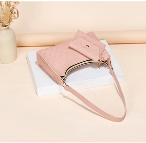 Detail of pink embossed PU shoulder bag with matching wallet and textured finish