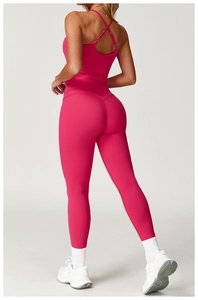 Detail of rose red yoga set featuring criss-cross back sports bra and high-waist leggings