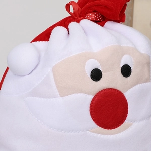 Large red velvet Santa Claus gift bag with polka dot drawstring and plush details