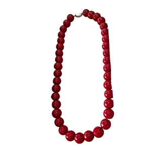 Minimalist red round beaded choker necklace with metallic clasp on white background