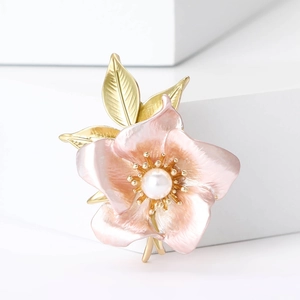 Macro detail of high-end pink enamel narcissus brooch with pearl and golden petals
