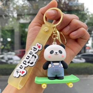 Detailed close-up of a silicone panda keychain on a skateboard with a panda letter strap