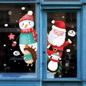 Festive Christmas window stickers featuring Santa, snowman and penguin on a blue glass door