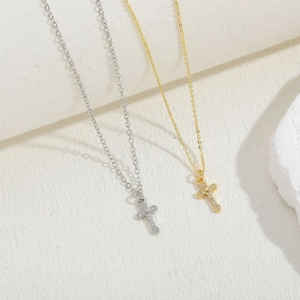 Close-up of gold and silver cross necklaces with micro-pave cubic zirconia crystals