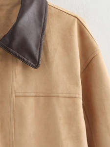 Detail of khaki faux suede coat showing dark brown leather collar and premium stitching