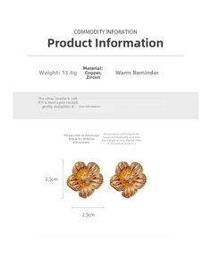 Detail view of 18k gold plated flower earrings with cubic zirconia and silver needles