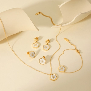 Detailed set of gold stainless steel necklace and bracelet with white shell flower pendants