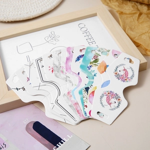 Various patterned jewelry display cards for earrings and necklaces with a scalloped edge design