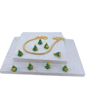 Christmas gold snake chain bracelet with green enamel tree charms on white geometric stand