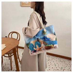 Close-up of canvas tote bag with beach vacation print and thick rope handles