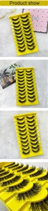 Macro view of 10 pairs of thick, wispy 3D faux mink eyelashes on a yellow tray