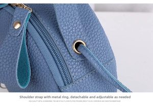 Detail of lychee pattern leather and gold metal buckle with adjustable shoulder strap
