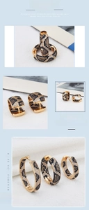 Detail of gold leopard print hoop earrings set with black and brown zircon stones