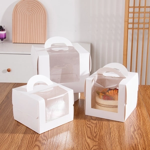 White cardboard cake boxes with large clear windows and handles for dessert packaging