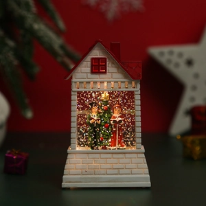 Close-up of lighted Christmas house decoration with Santa Claus and sparkling glitters