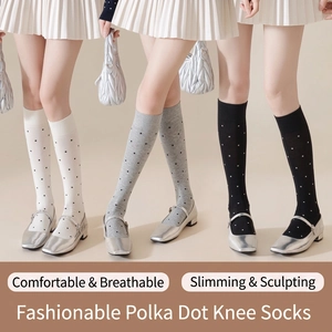 Three pairs of vintage polka dot calf socks in white, gray, and black for women