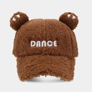 Close-up of brown plush baseball cap with bear ears and white DANCE embroidery