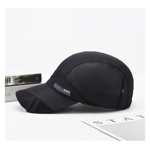 Detail of breathable black mesh fabric and white SPORTS logo on the side of baseball cap