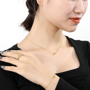 Detailed set of gold paw print jewelry featuring necklace, bracelet, ring and earrings