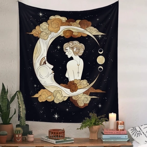 Detail of bohemian wall tapestry featuring golden sun and moon art in a cozy bedroom