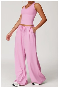 Detail of pink lounge set featuring high waist wide leg pants and a V-neck tank top
