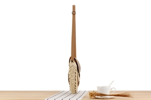 Side view of woven round straw crossbody bag with adjustable brown PU shoulder strap