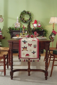 Detailed view of jacquard Christmas table runner with red tassels and snowflake patterns