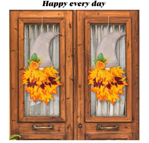 Detail of harvest gnome door decor with orange maple leaves and grey fabric hat