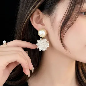 Elegant silver needle floral pearl drop earrings featuring white cream texture petals