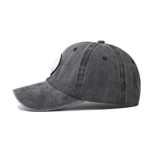Detail of washed charcoal cotton baseball cap with smiley patch and vintage stitching