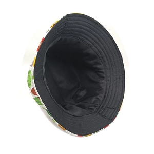 Detail of printed bucket hat showing reinforced stitching and colorful vegetable patterns