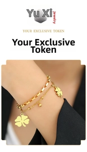 Double-layer gold clover bracelet with box and bead chain on a female model